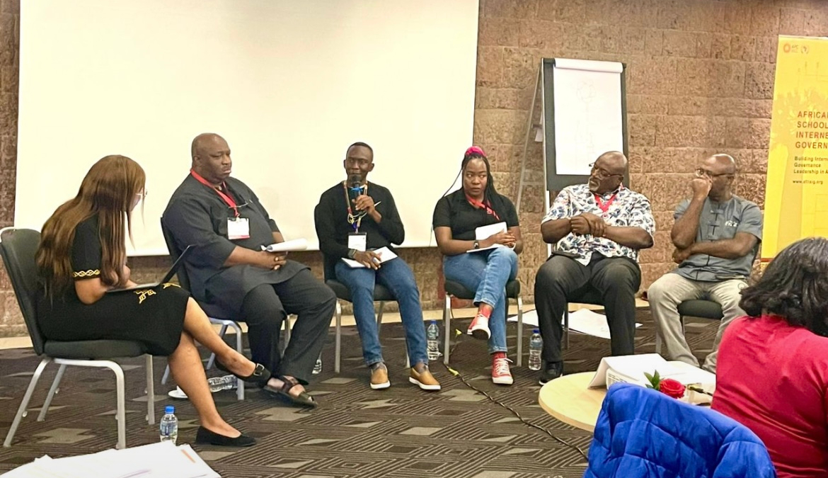 Image: AfriSIG 2024 fellows sit together on a stage, listening to an exchange of ideas. Photo courtesy of AfriSIG 2024 fellows.